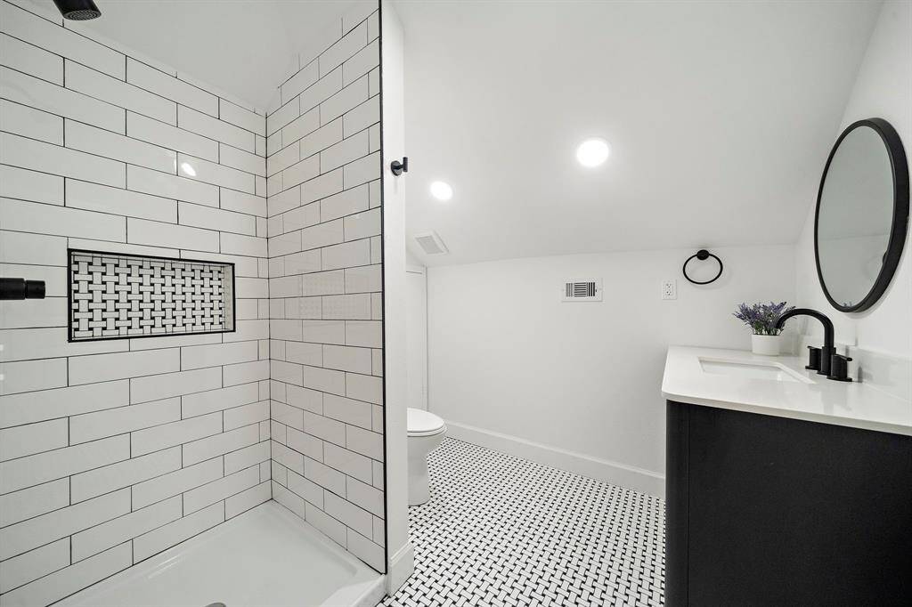 Spacious walk-in shower with recessed shower niche providing a clean, clutter free storage solution.