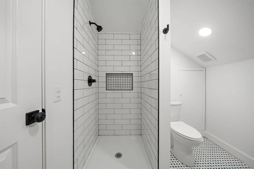 Vanity with sleek modern design adds ample storage to this space