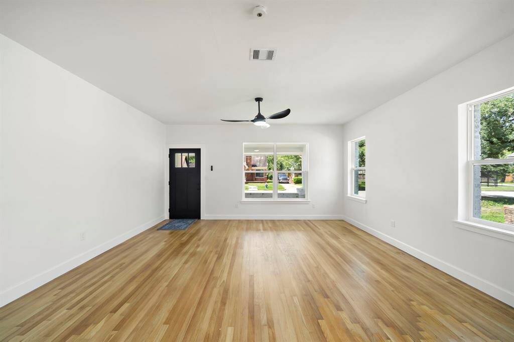 Step into a sun-drenched living area that perfectly blends warmth and modern simplicity. Beautifully refinished hardwood floors that are original to the home.