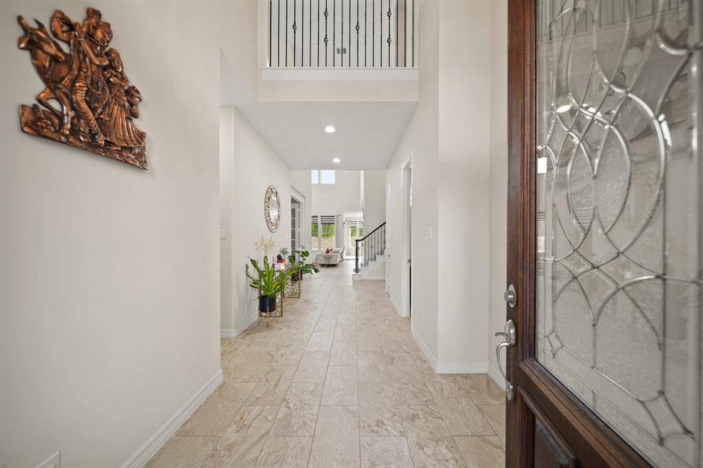 You will be greeted by gorgeous tile floors, high ceilings, and a view straight into your backyard.