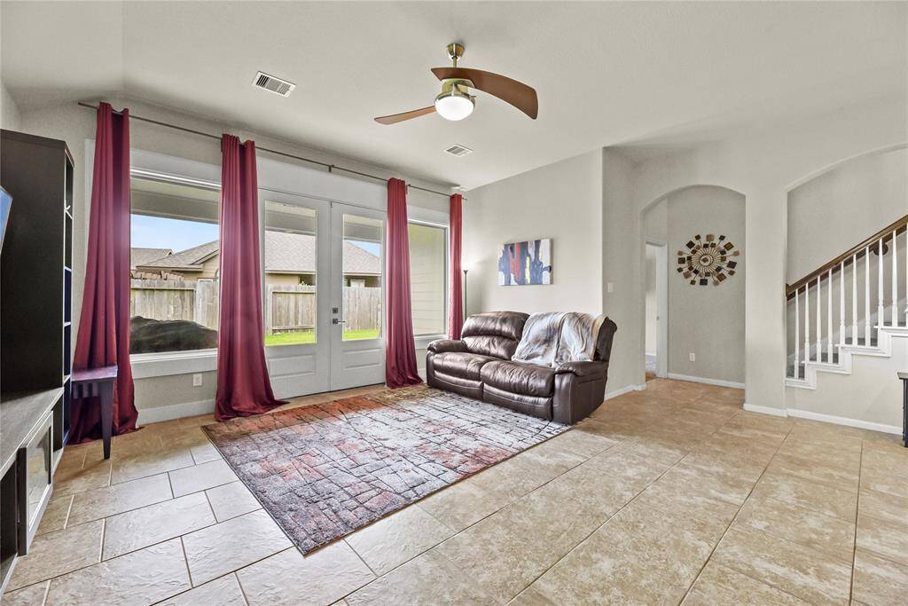 This expansive space is filled with natural light, thanks to stunning floor-to-ceiling windows that frame the outdoors and enhance the open, airy feel.