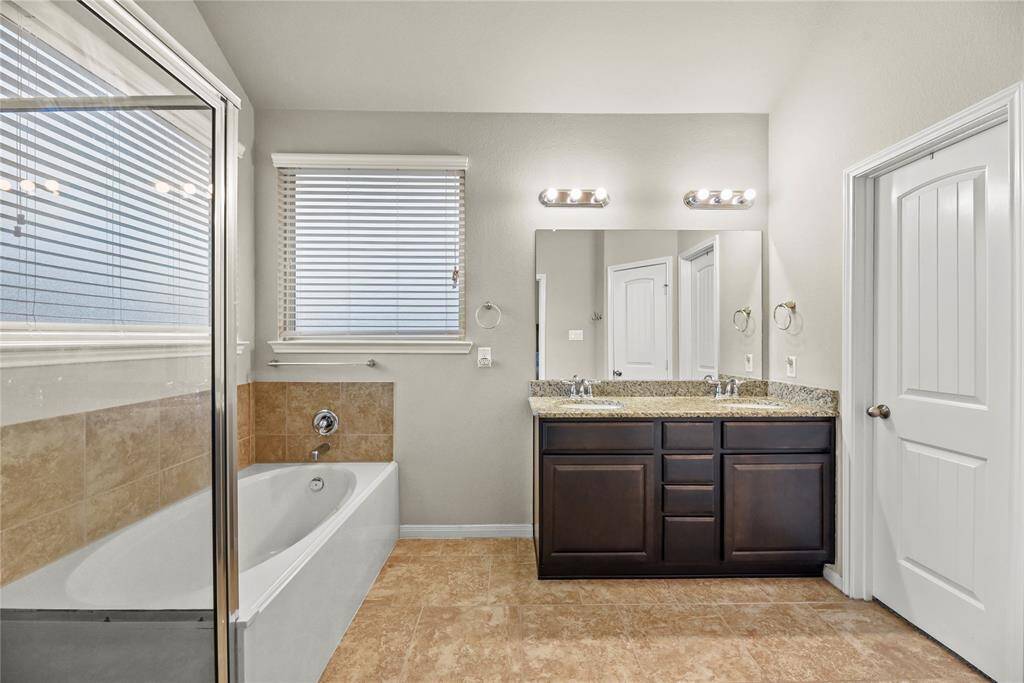 Dual vanities in your primary bath, offer personal space dedicated cabinet space.
