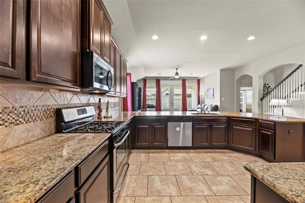 Rich cabinetry offers a clean, timeless aesthetic that elevates the space with a sense of brightness and openness.