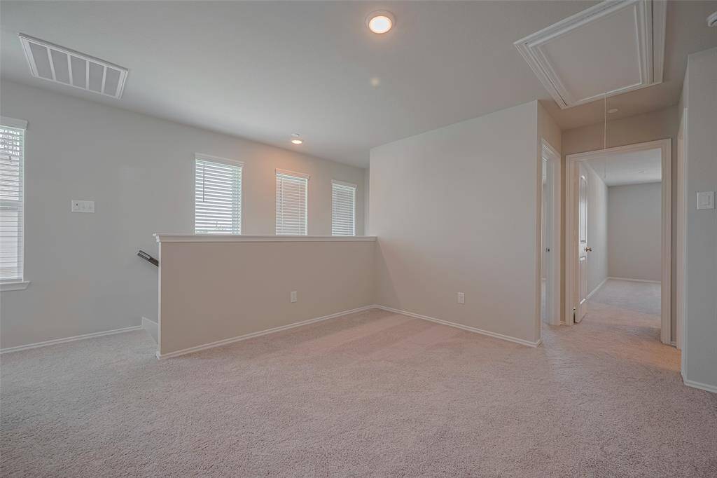 The game room, located right at the top of the stairs, is a bright and versatile space—perfect for a playroom, home office, or additional TV room. As an end unit, it benefits from extra windows that fill the room with natural light, creating a cozy yet open feel.
