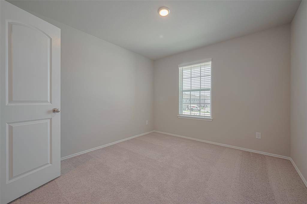 Another guest bedroom featuring recessed lighting, cozy carpet, and a big window, this guest bedroom combines comfort and functionality with ample closet space