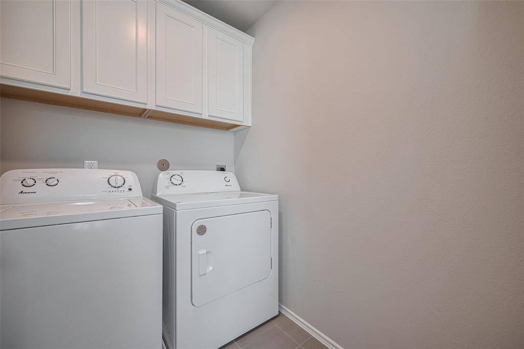 This home includes never-used white appliances, conveniently located near the bedrooms for easy access and everyday convenience.