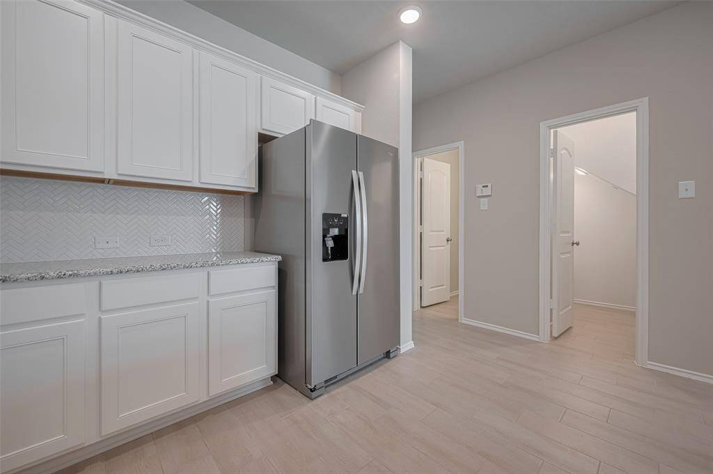 This view shows the half bath and oversized storage pantry.