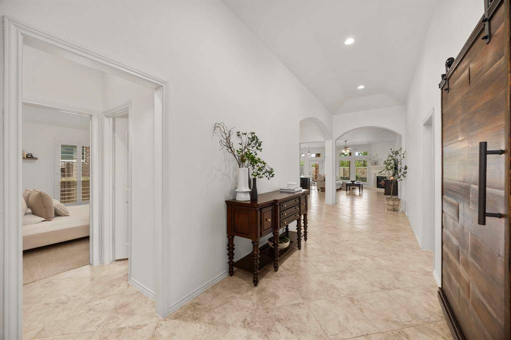 Simple, beautiful, and elegant with rustic charm! Dramatic high ceilings, lots of architectural details and archways showcasing this oversized entryway!