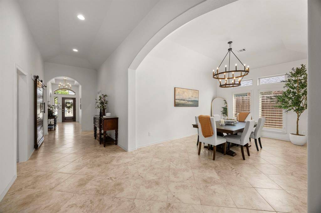 Beautiful tile flooring showcasing expansive entryway and dining room. Lots of architectural details, high ceilings, and archways.