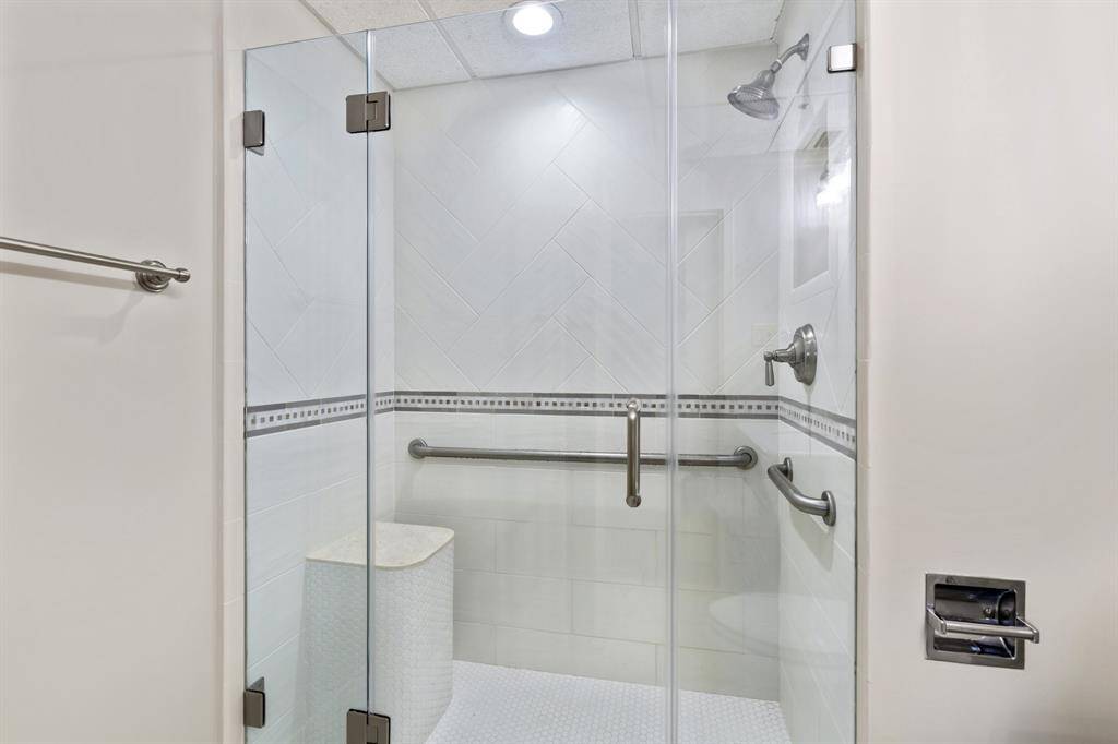 Shower detail with bench and grab bars.