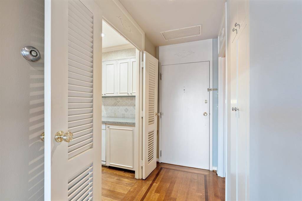 Entry view with the kitchen on the left and a powder room on the right.
