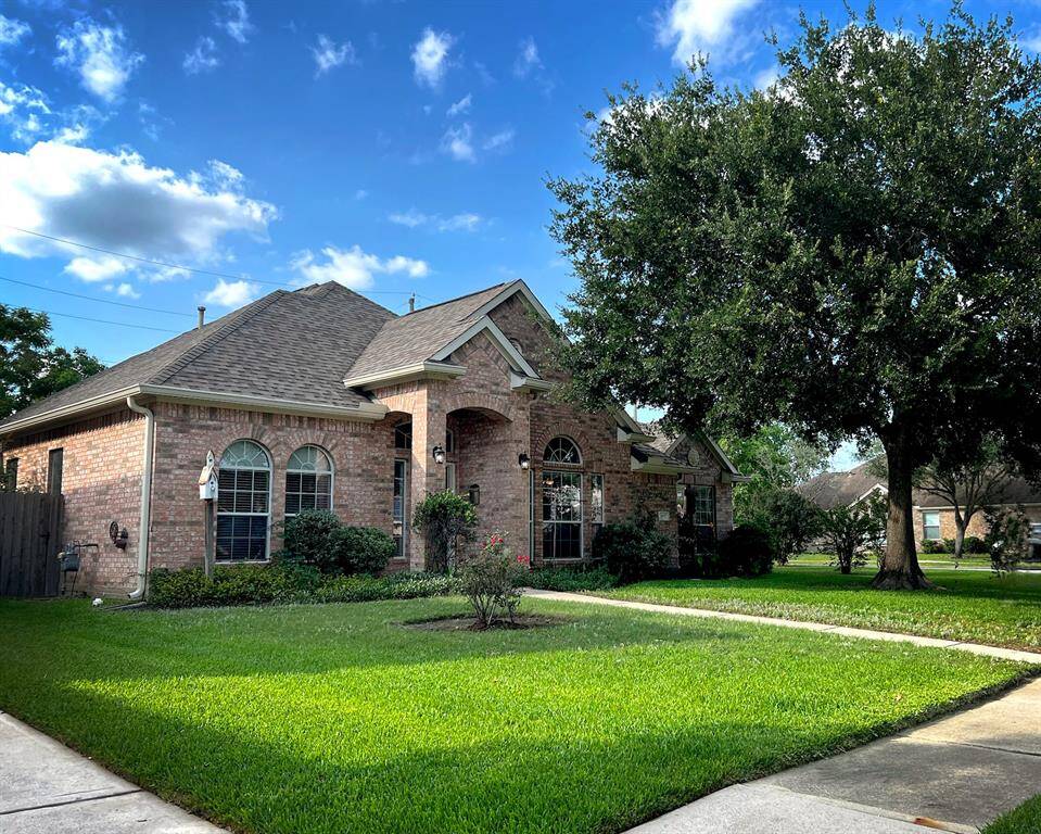 Charming 1-story brick home with a gabled roof, a well-maintained lawn and mature trees. Large arched windows add class and lots of natural light, and a welcoming front porch enhances this beauty's curb appeal.