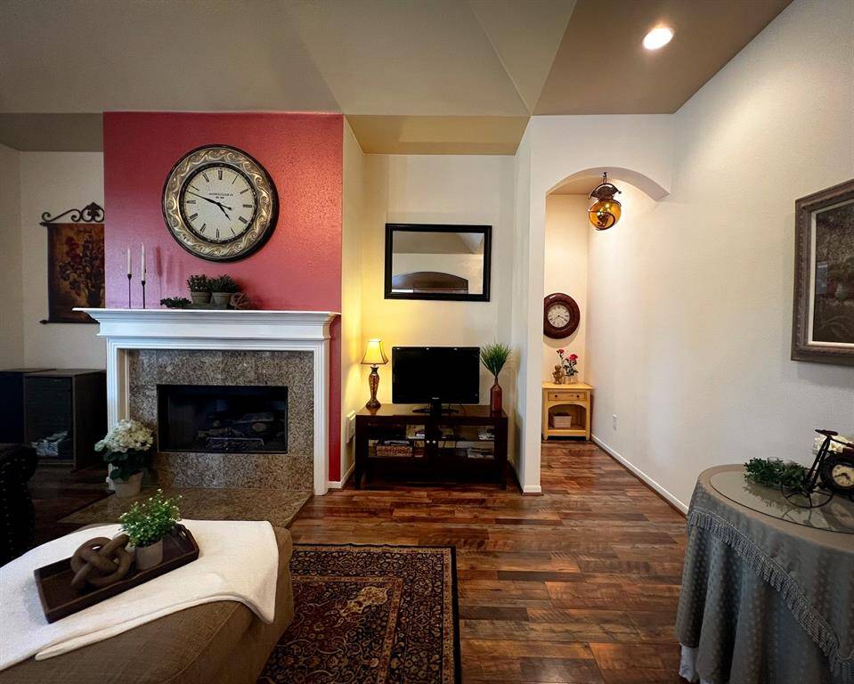 Decorate your mantel to make this space your own! This photo also shows the hallway leading to the powder bathroom, and primary en-suite bedroom that sits on the back side of the home.