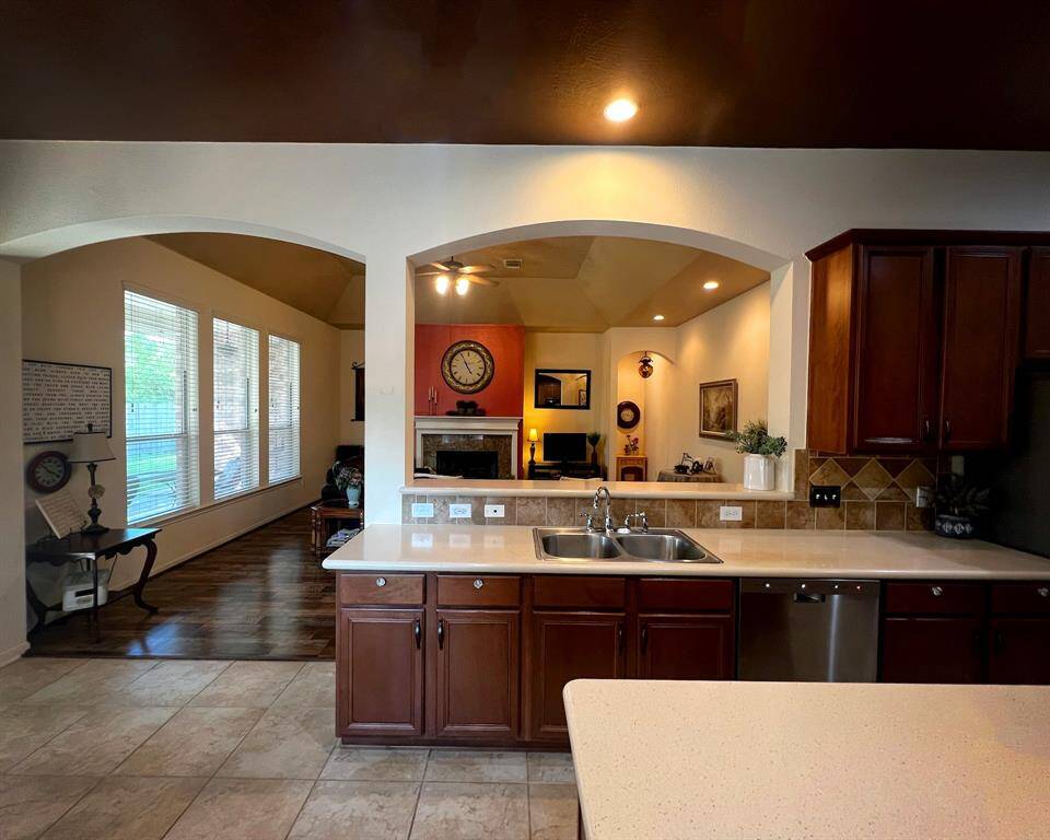 The open-concept kitchen offers a view into the living area.