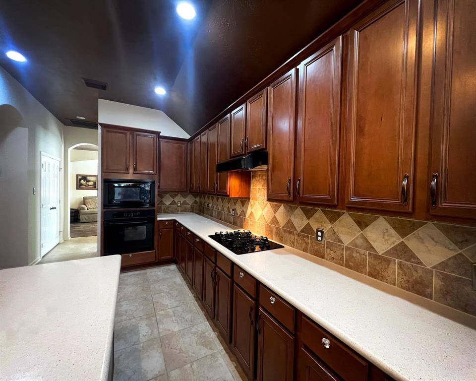 The built-in oven, and a sleek gas cooktop deliver an element of luxury in this J. Patrick Homes custom build.