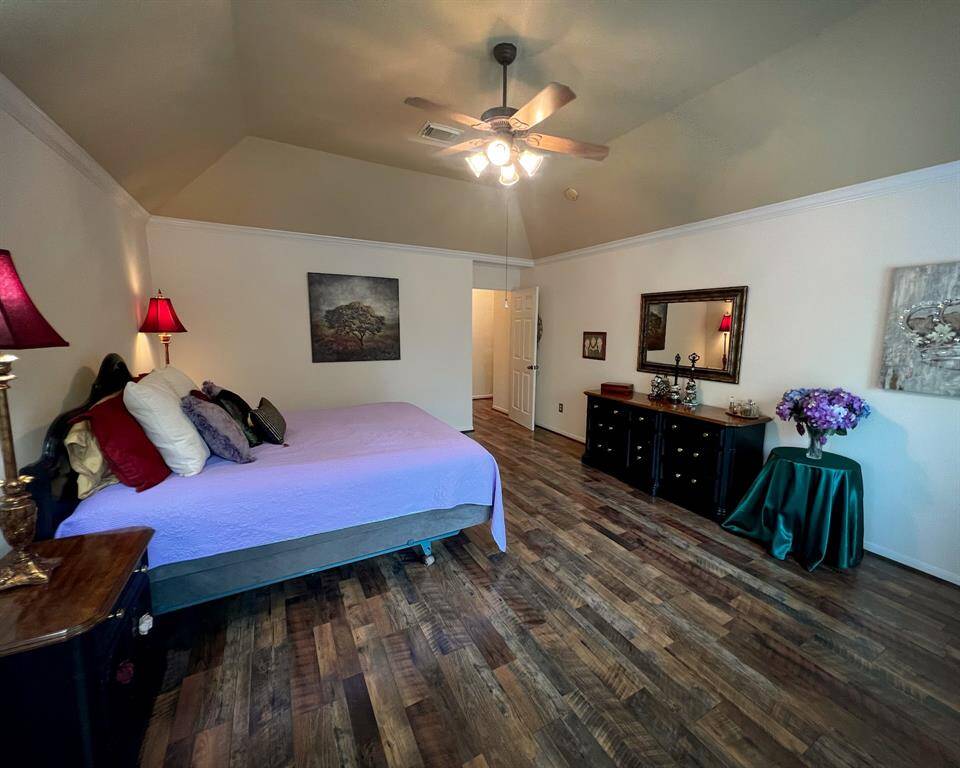 You won't believe the size of this primary bedroom with vaulted ceilings, spectacular laminate wood flooring, ceiling fan and neutral paint colors.