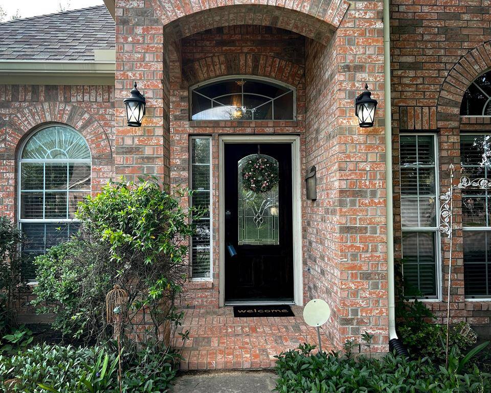 Beautiful brick facade with an inviting front entrance, and covered porch.