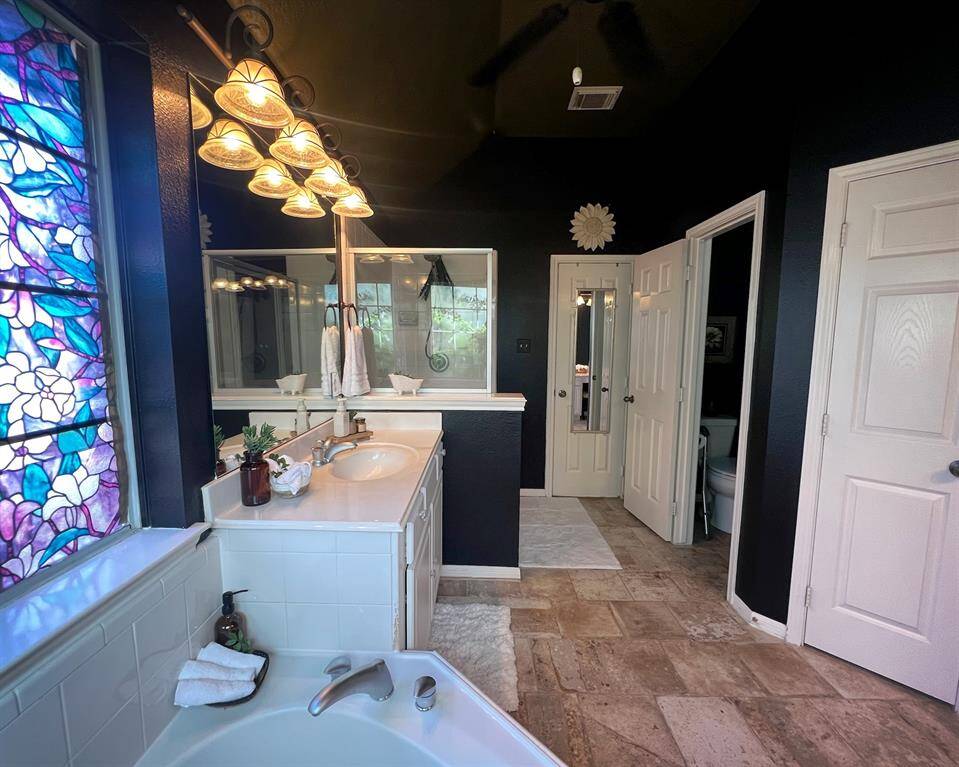 A view of the water closet and adjacent linen closet  on the right for all your storage needs.