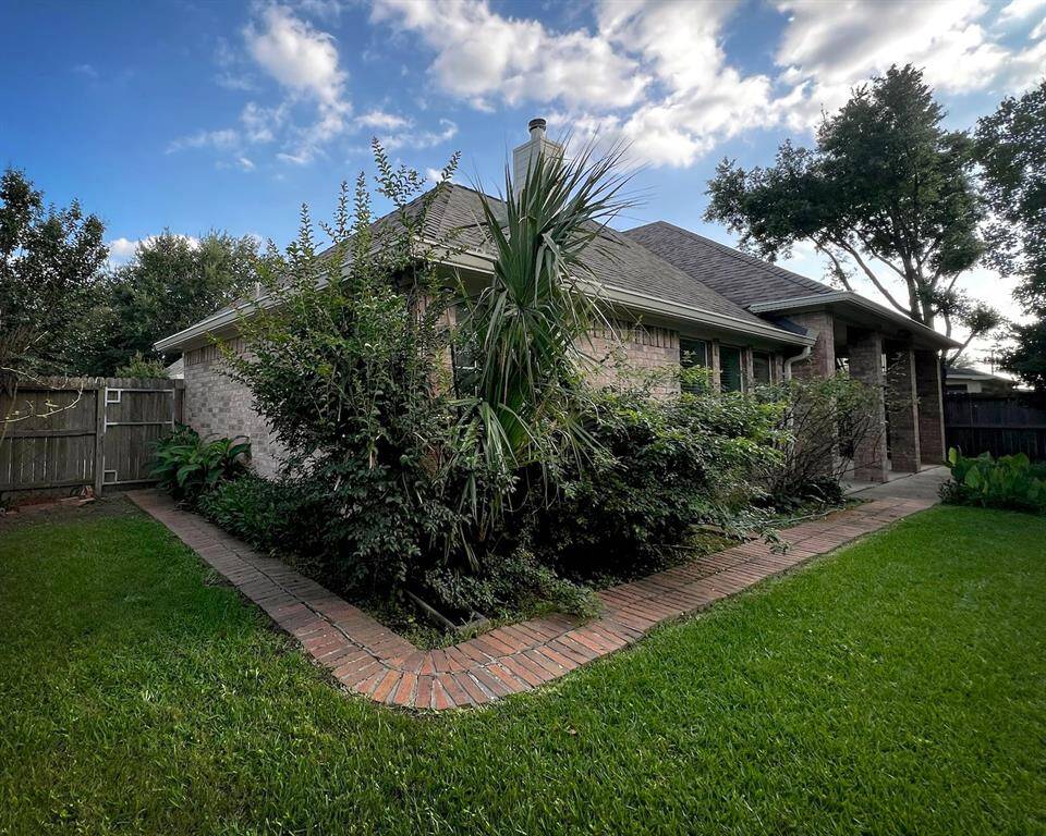 This attractive backyard comes outfitted with an enchanting garden bed, featuring lush greenery and a handsome, bricked, corner pathway. It offers a private fenced yard, and no rear neighbors!
