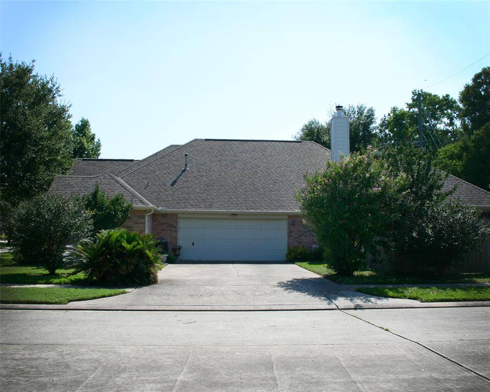 The unique oversized two-car garage is located at the side of the home, providing a sense of privacy. The driveway is spacious and offers additional parking.