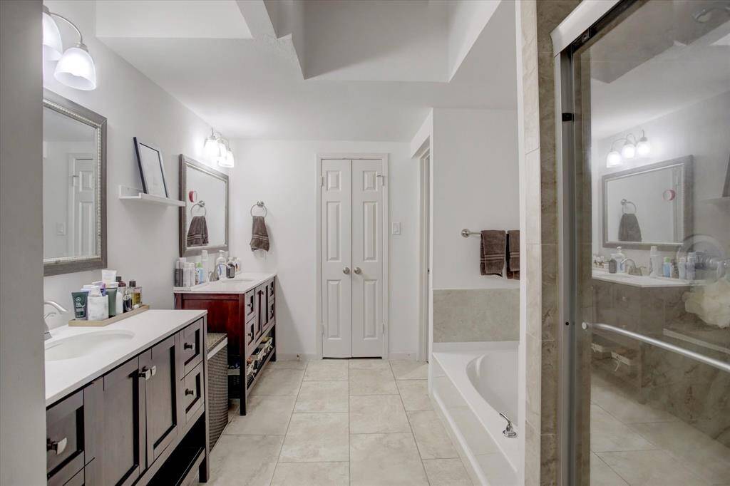 Primary bathroom with double sinks, separate shower and tub