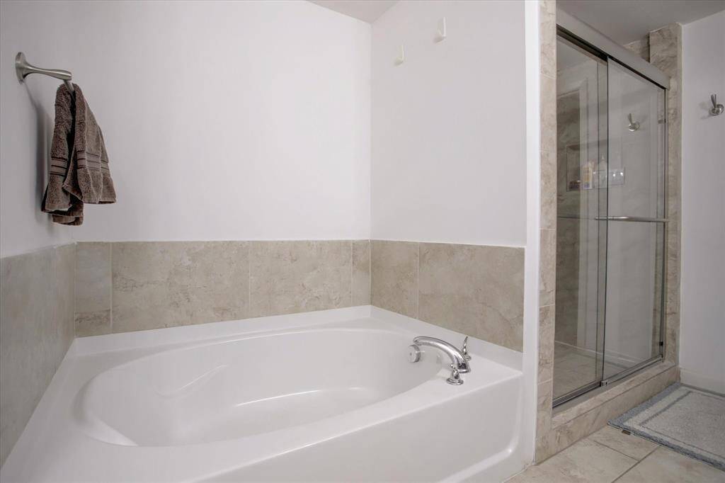 Primary bathroom with double sinks, separate shower and tub
