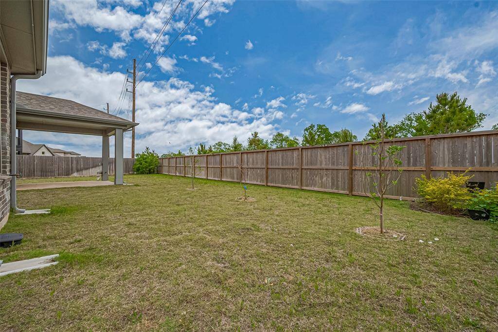 Spacious backyard with a covered patio, perfect for outdoor activities/entertaining and is fenced for privacy.