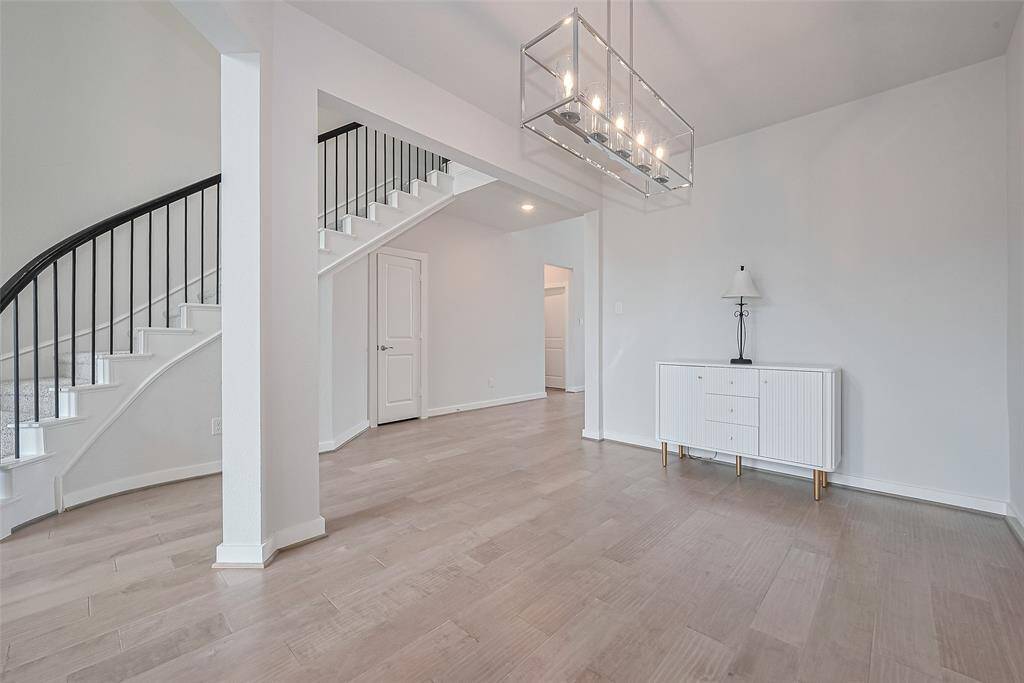 Stunning staircase adds architectural elegance charm and sophistication and serves as a striking focal point in the homes open layout.