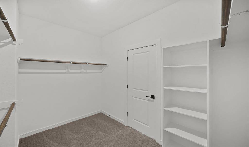 Walk-in closet in primary suite (*Photo not of actual home and used for illustration purposes only.)