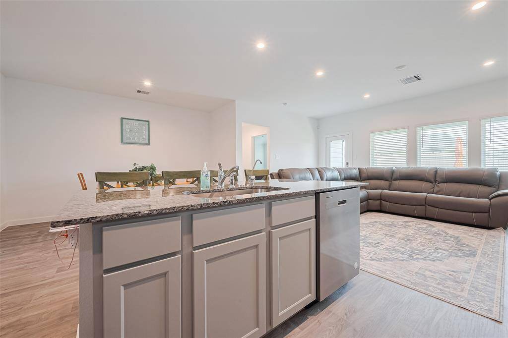 The kitchen island looks out toward the dining area in front and living area to the side, making it a true hub for connection.
