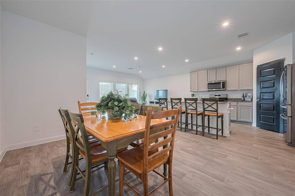 The dining area sits just across from the kitchen, perfectly positioned for easy meals and open interaction with the living room.