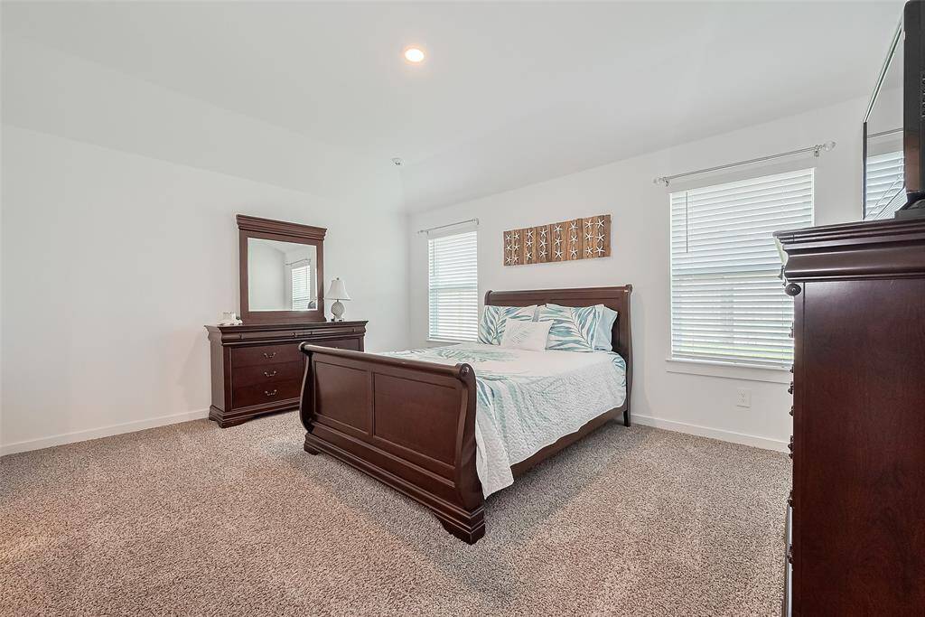 This spacious bedroom is finished in plush carpet and designed to feel like a personal retreat.