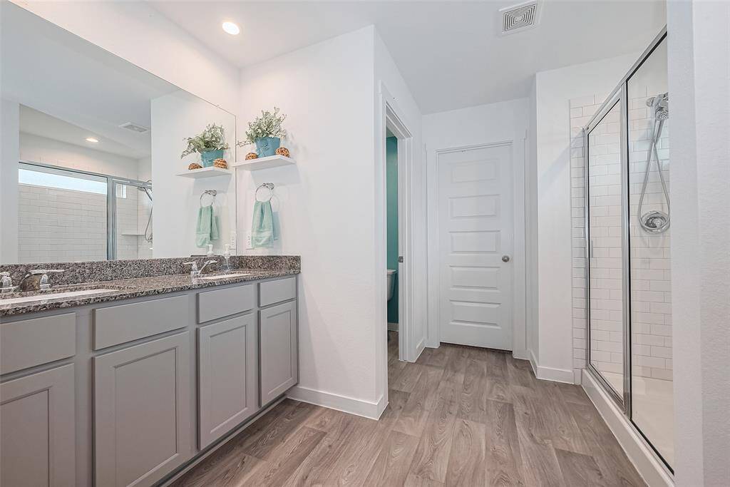 A practical layout places the large shower directly across from the double vanity, maximizing the use of space.