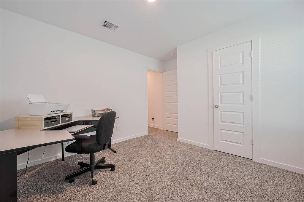 Another spacious carpeted room offers flexibility for sleeping quarters, creative space, or guests.