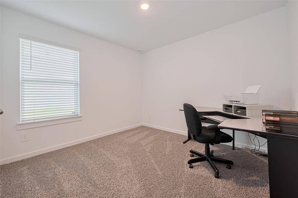 This room features a large window and recessed lighting—making it an excellent candidate for a home office.
