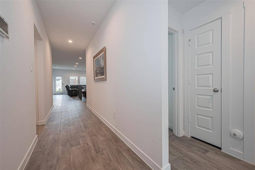 From the entryway, the home's interior draws you in with a glimpse into the main living areas beyond.