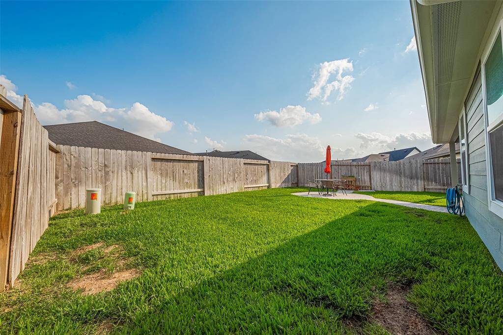 The fully fenced backyard provides generous room for play, gardening, or future enhancements.