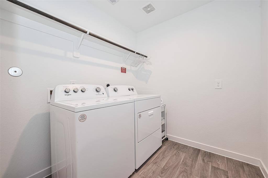 A built-in rack and overhead hanging rod make the laundry room both efficient and functional.