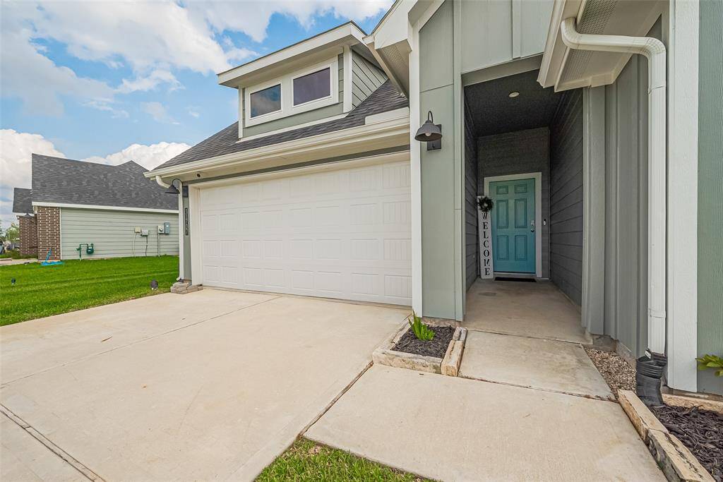 The main entry is tucked into a recessed area beside the garage, providing both shade and privacy.