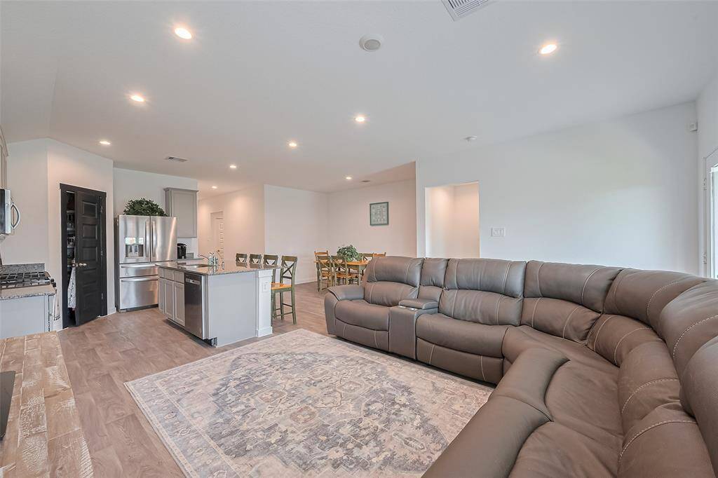 A single frame captures the thoughtful openness of the layout, highlighting the interconnectedness of the kitchen, living, and dining spaces.