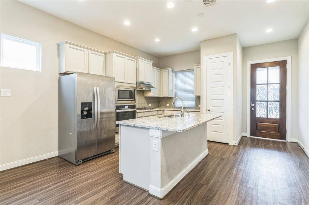 Entry leads into kitchen and open concept living/dining space