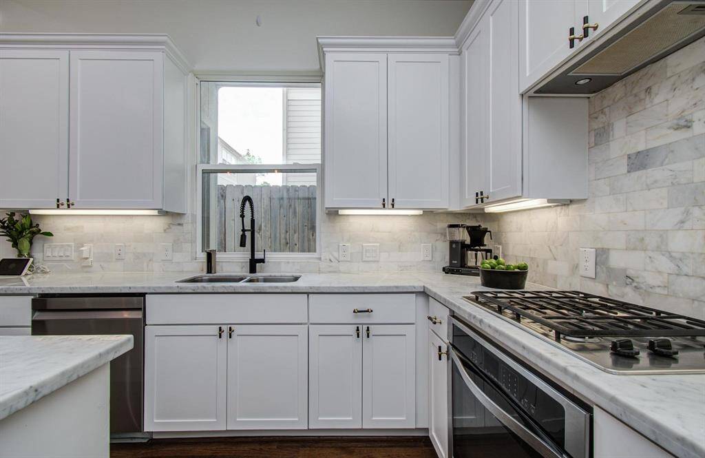 Your beautiful kitchen features tons of cabinet storage, a spacious walk-in pantry, and sleek marble countertops—functional and stylish all in one.