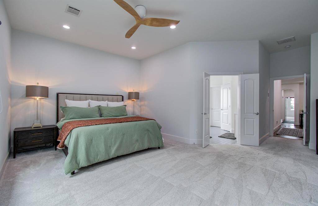 Look at the size of this primary suite—so much space and gorgeous natural light! It also features an en suite bath and a generously sized walk-in closet.
