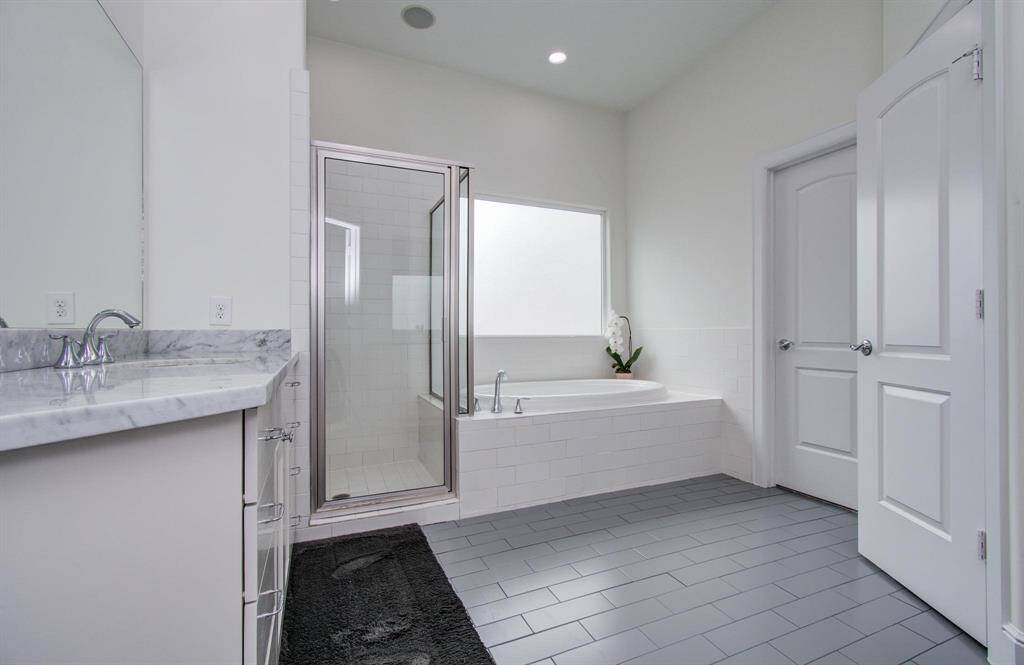The spacious primary en suite bath offers double vanities, abundant cabinet and drawer storage, and plenty of counter space. Enjoy both a walk-in shower and a soaking tub for ultimate relaxation. The private water closet adds convenience—everything you need in a beautifully designed bathroom.