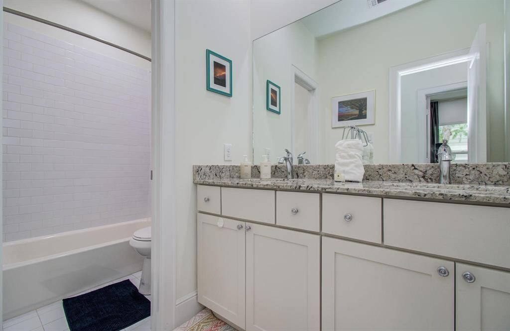 This full hall bath sits between the two secondary bedrooms—perfect for guests or family, with a functional layout and easy access from both rooms.