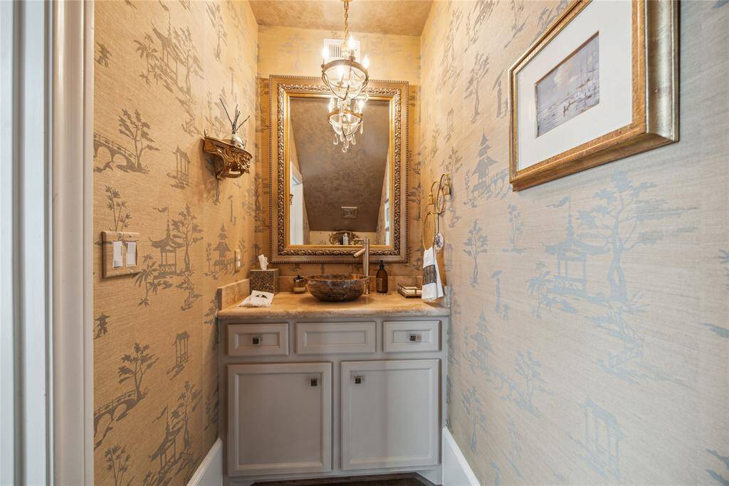 An elegant half bath is tucked discreetly near the staircase, providing convenient access for guests and serving the main living areas on the first floor.