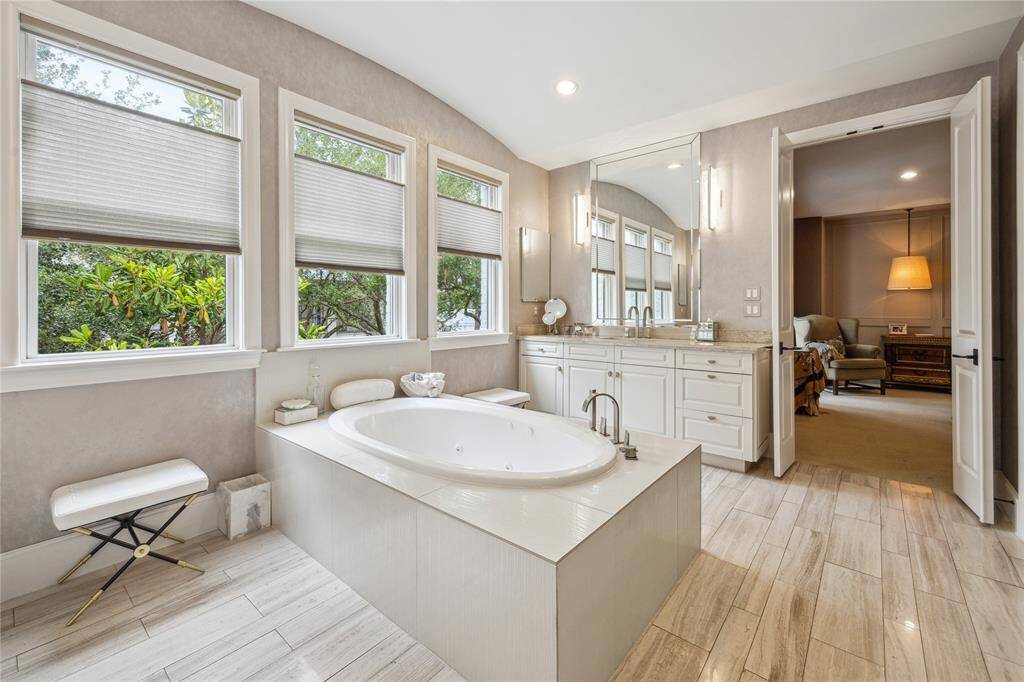 Relax and unwind in the large, jetted tub, ideally positioned to take advantage of the natural light and serene ambiance of the primary bath.