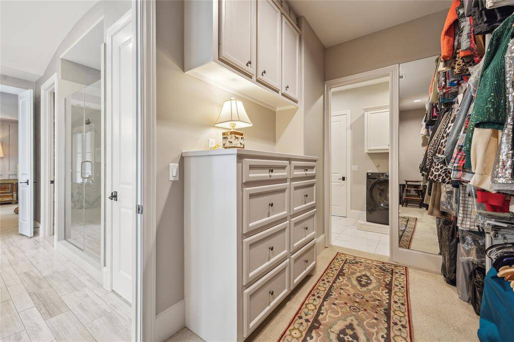 Here’s a peek at one of the two expansive primary closets. This one offers the added convenience of direct access to the laundry room, making daily tasks that much easier.