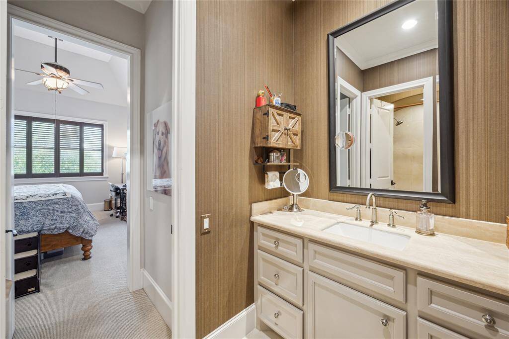 The secondary bedroom with this ensuite bath also includes a walk-in closet.