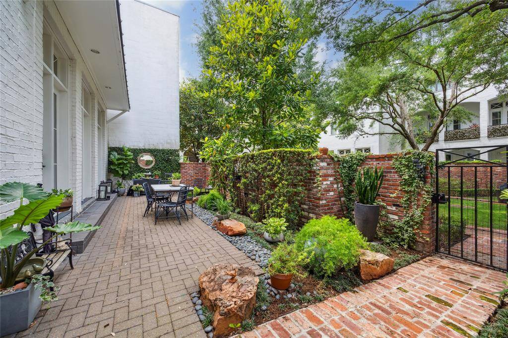 The backyard patio brick pavers is surrounded by meticulously manicured landscaping, creating a peaceful outdoor retreat.